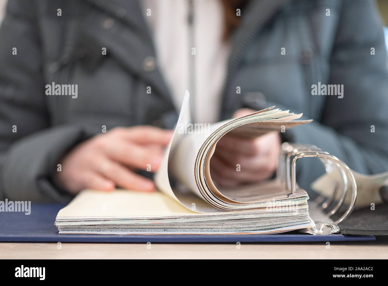 Buyer is choosing a products in a store catalog close up Stock Photo