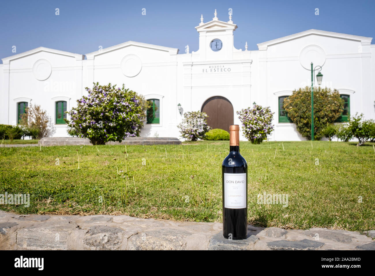 Don David red wine bottle with the Bodega El Esteco (Winery Estate) characteristic main building in the background in Cafayate, Argentina Stock Photo