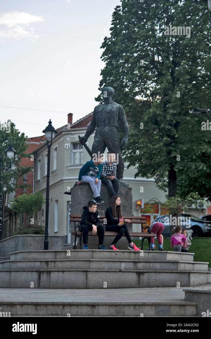 Raska, Serbia, May 03, 2019. A group of children play and rest at the monument downtown. Stock Photo