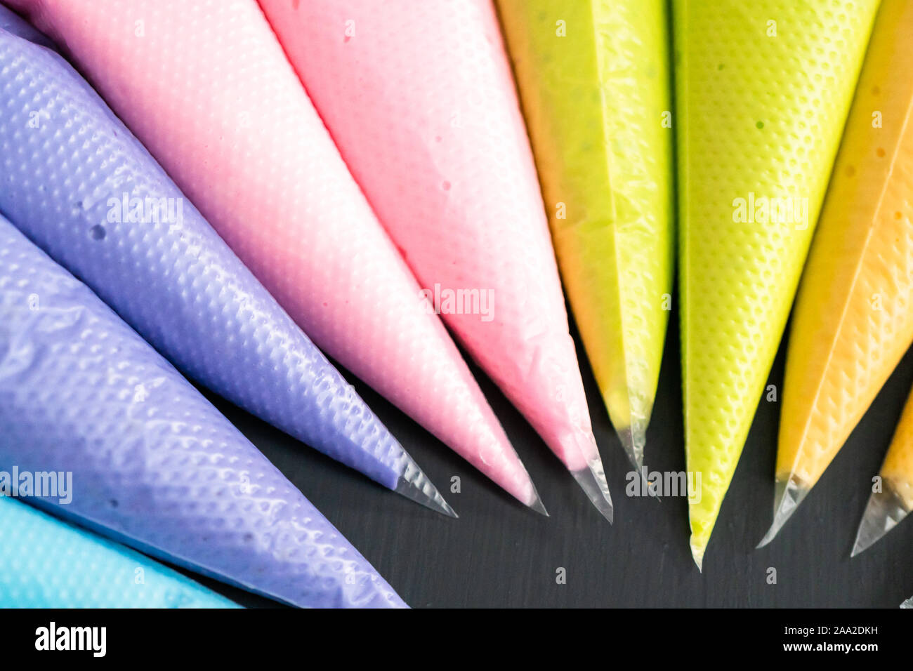 Variety of colors of royal icing in plastic piping bags Stock Photo Alamy