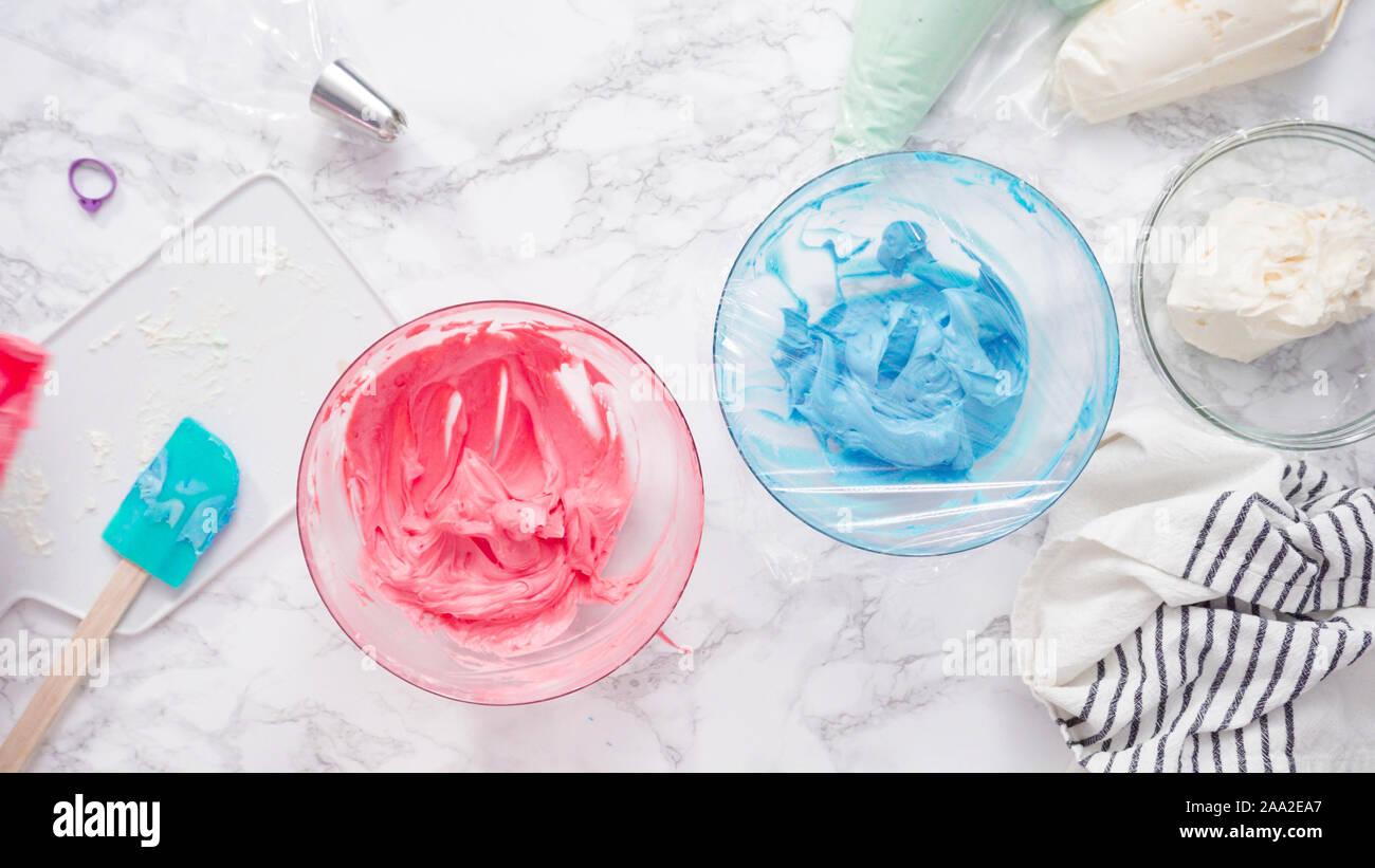Mixing food coloring with buttercream frosting Stock Photo Alamy