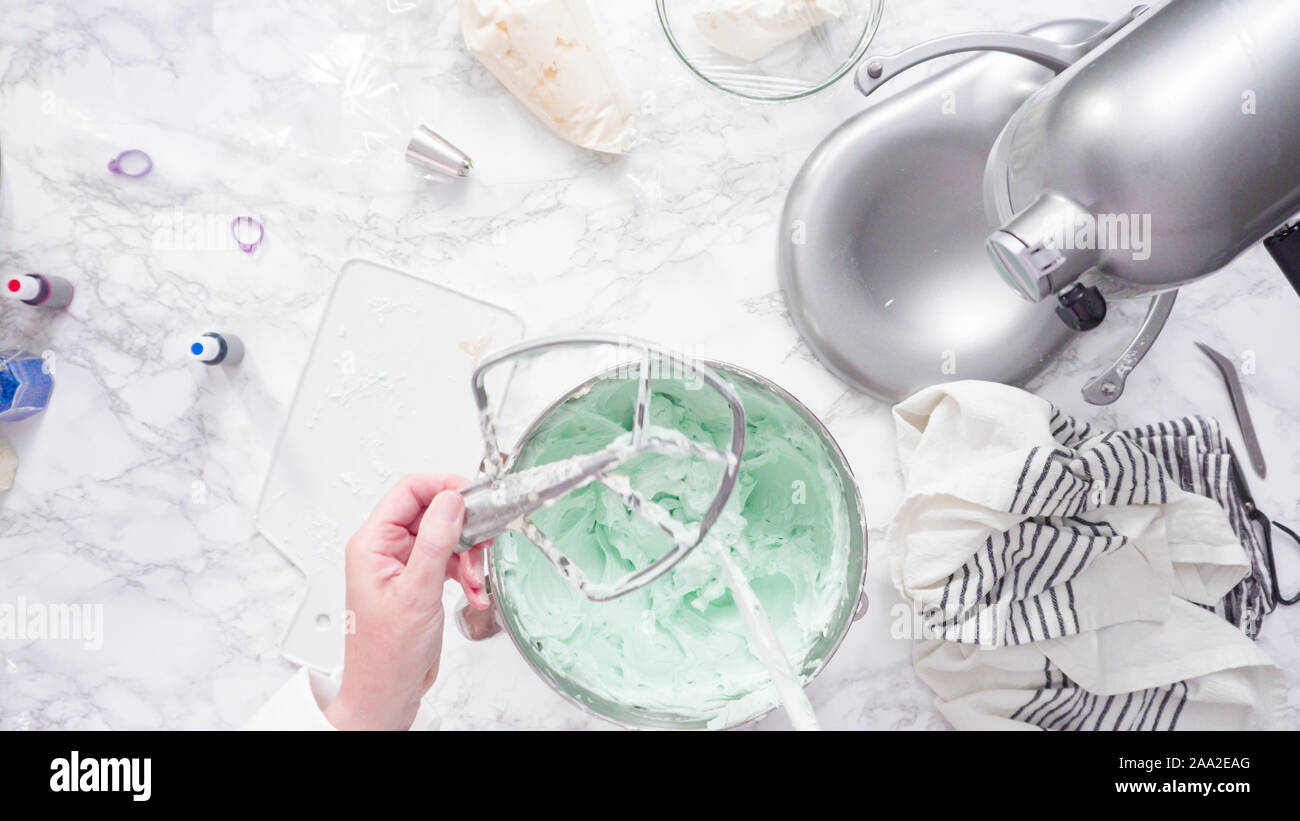 Mixing ingredients in standing kitchen mixer to make buttercream