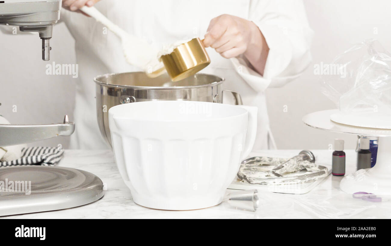 Mixing ingredients in standing kitchen mixer to make buttercream