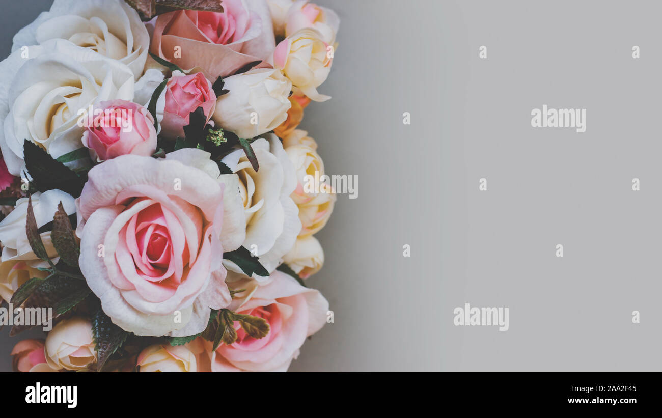 Bouquet of artificial pastel color flowers on gray background, top view with copy space Stock Photo