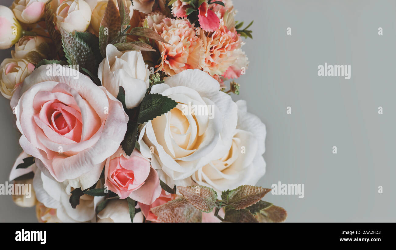 Bouquet of artificial pastel color flowers on gray background, top view with copy space Stock Photo