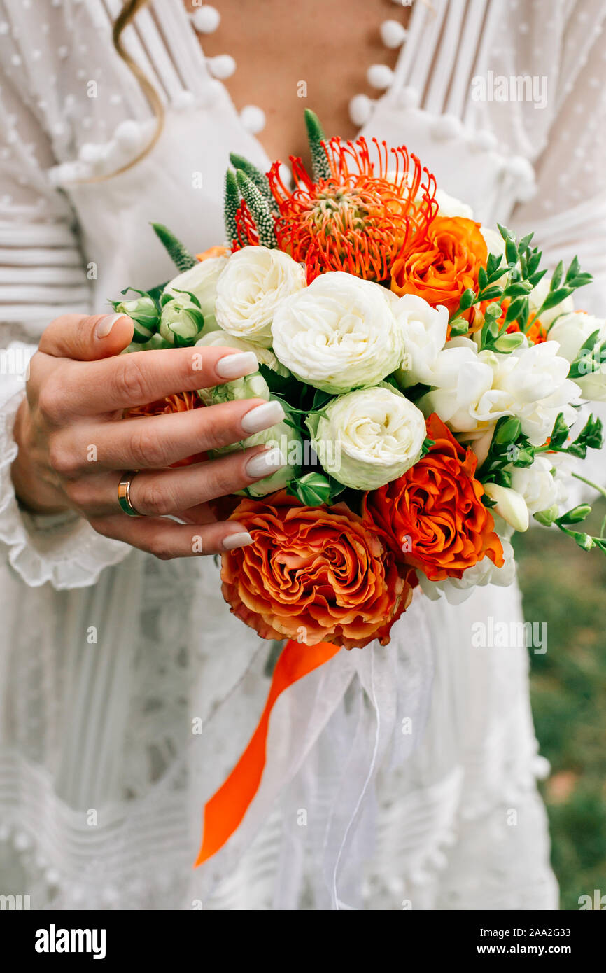 Beautiful Autumn Wedding Bouquet With Orange Roses In Hands Of The