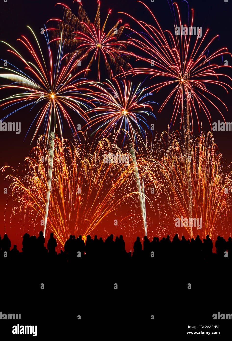 Silhouette of people at a firework display. Stock Photo