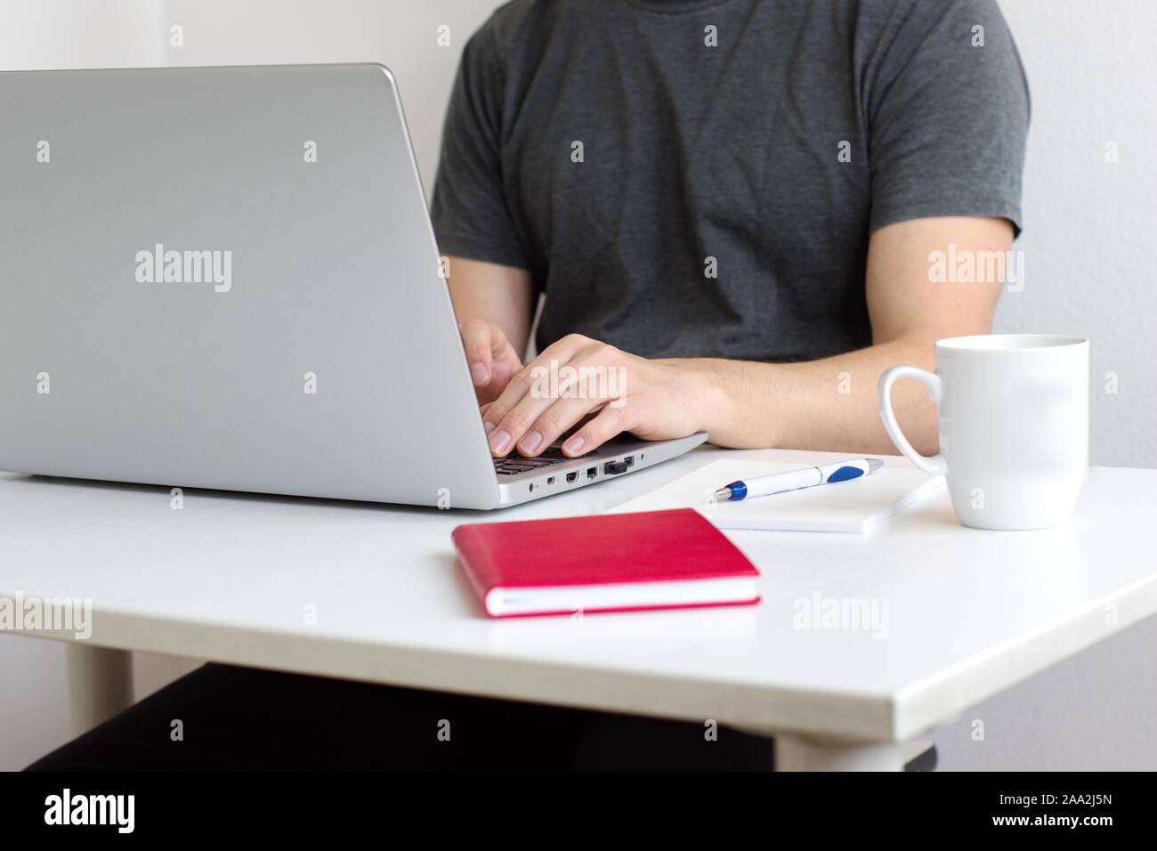 Midsection of young man using laptop Stock Photo