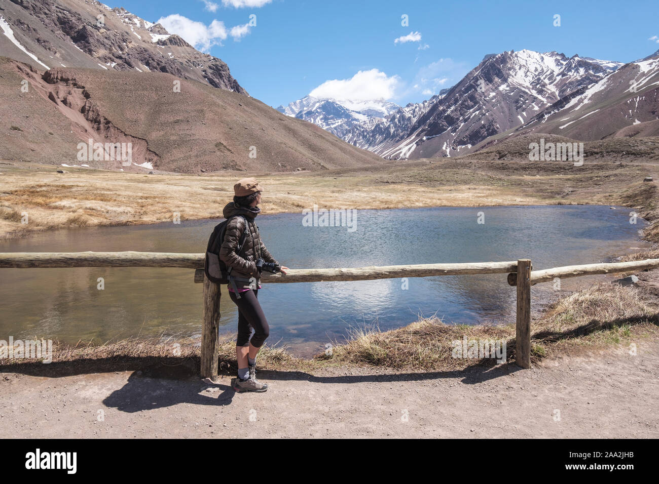 Female visitor on the Lagoon Los Horcones in the Aconcagua Park with the Mount Aconcagua in the background, Mendoza Province, Argentina Stock Photo