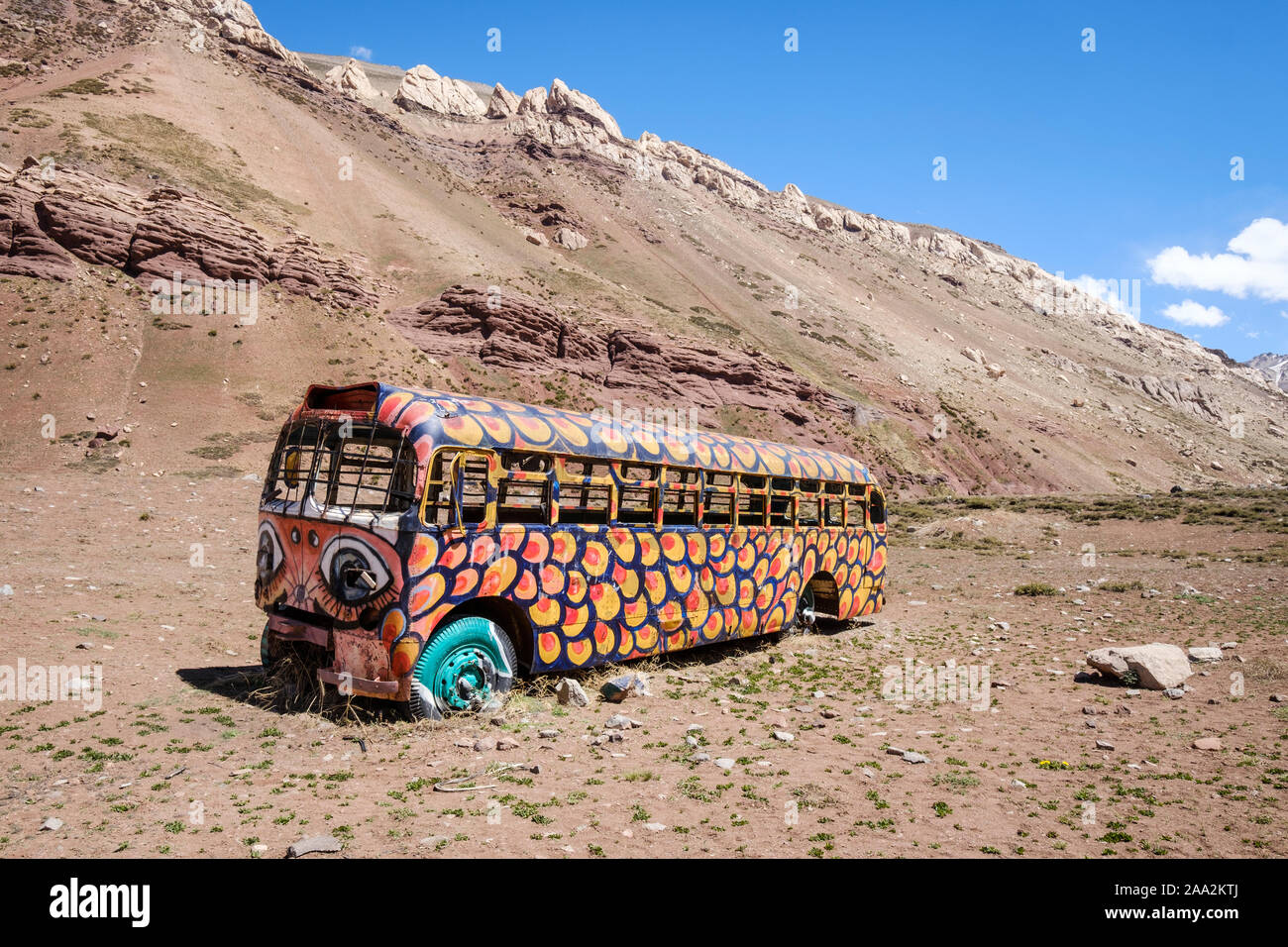 Abandoned painted bus on the Andean Mountain Range in Mendoza Province, Argentina Stock Photo