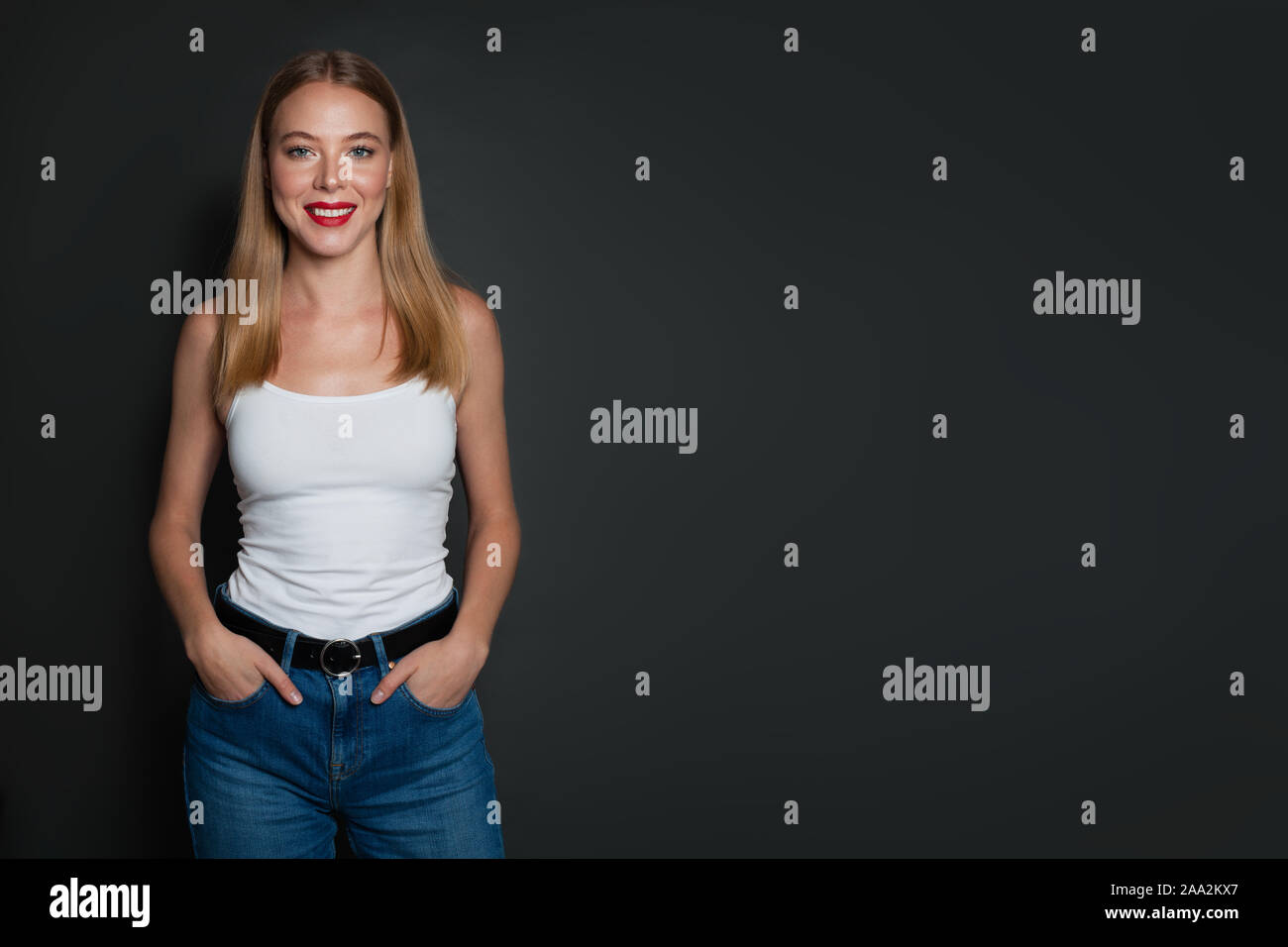 Pretty Woman Wearing Blue Jeans And White Shirt Standing On Gray Background With Copy Space Stock Photo Alamy Pretty Woman Wearing Blue Jeans And White Shirt Standing On Gray Background With Copy Space Stock Photo Alamy