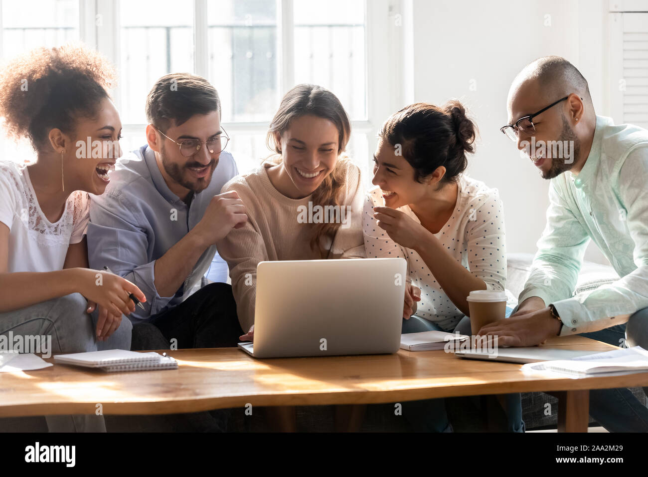 Overjoyed diverse millennial people having fun in dormitory. Stock Photo