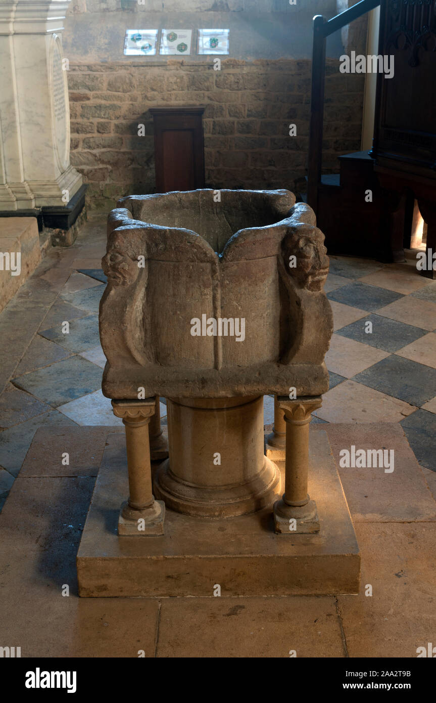 The 13th century font in St. Mary the Virgin Church, Fawsley, Northamptonshire, England, UK Stock Photo