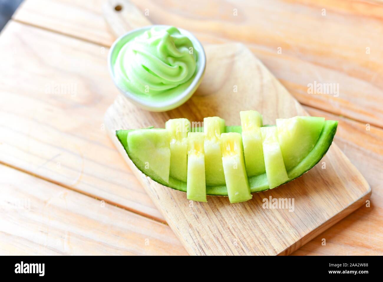 Fresh Japanese Green Melon Sliced on Wooden Board Stock Photo