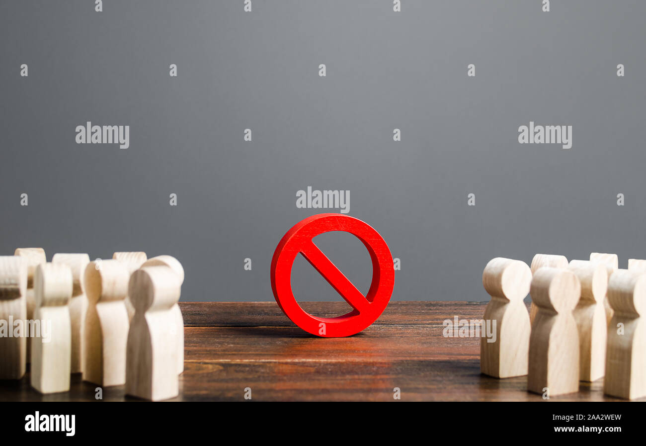 People looking at red prohibition sign NO. prohibition, taboo, and rejection. Conservatism, misunderstanding new. Laws Restrictions of rights and free Stock Photo