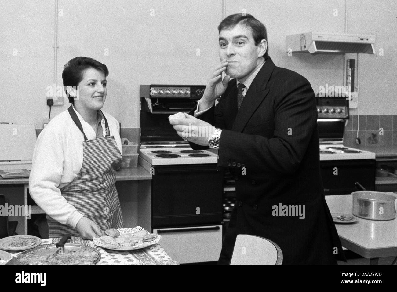 Prince Andrew munches a mine pie in the domestic science room ay Wycliffe School, County Durham, a top security centre for problem children. He is taking a tour of the premises after he opened the new £500,000 secure unit Royston House. Stock Photo