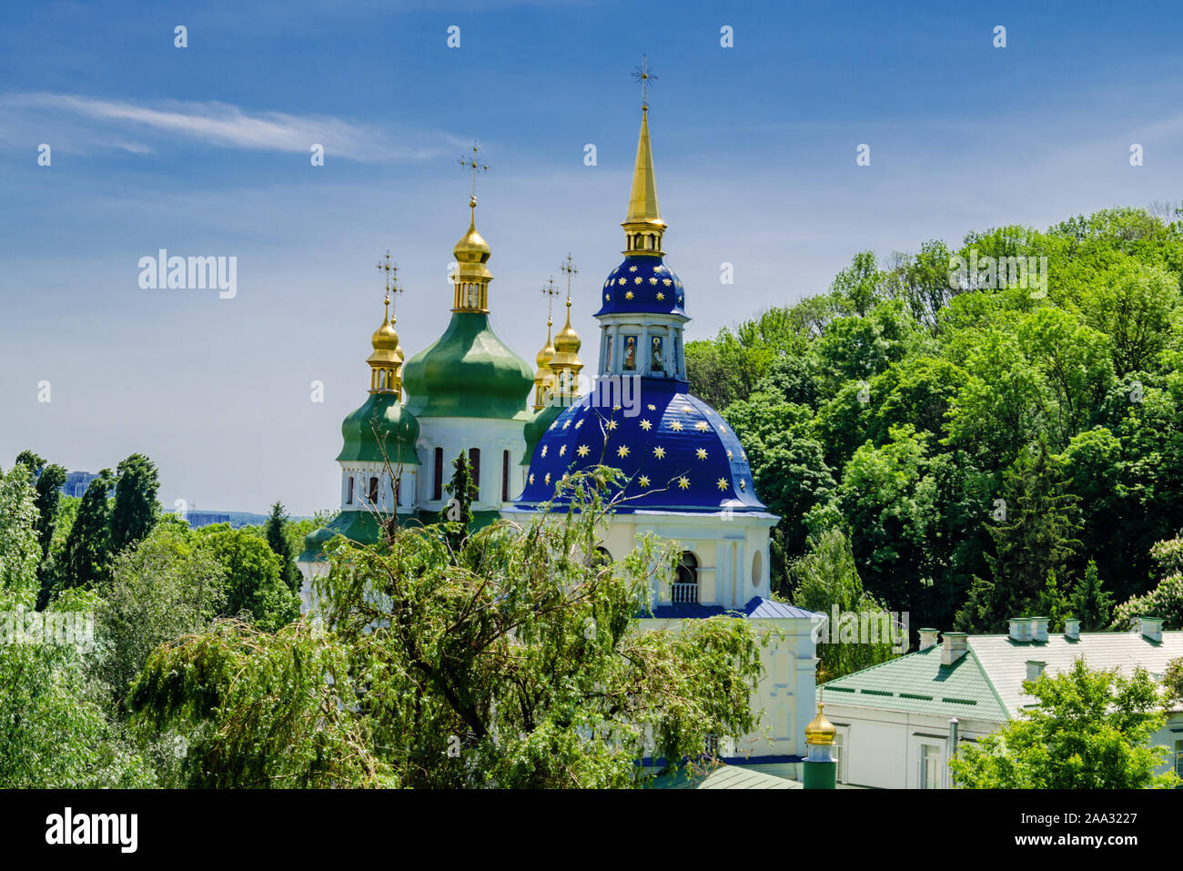 blue dome with a golden cross and golden stars, an Orthodox church in the botanical garden of Kiev, Ukraine, Stock Photo