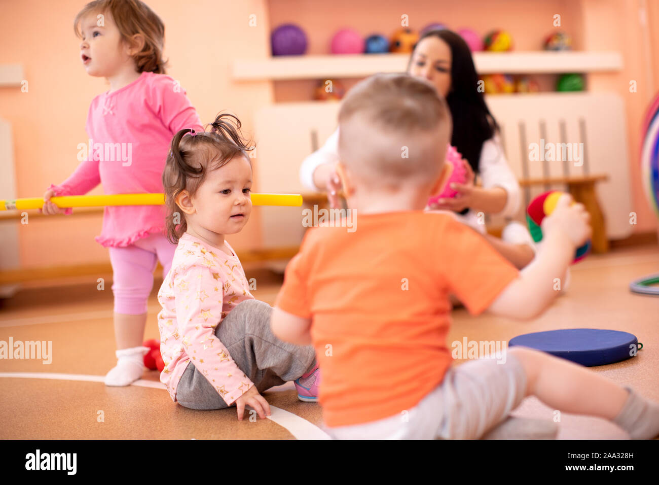 Nursery children with trainer in gym. Healthy lifestyle and child sport concept Stock Photo