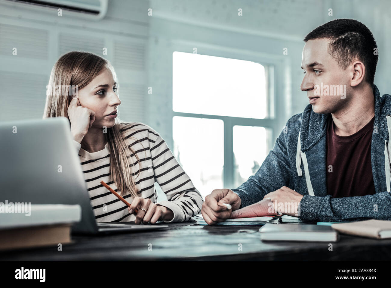 Pleasant nice couple studying at home together Stock Photo