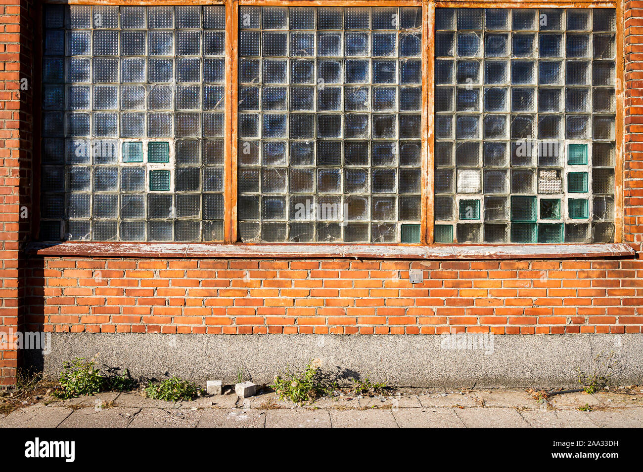 Red brick wall with glass block window. Architecture detail Stock Photo -  Alamy