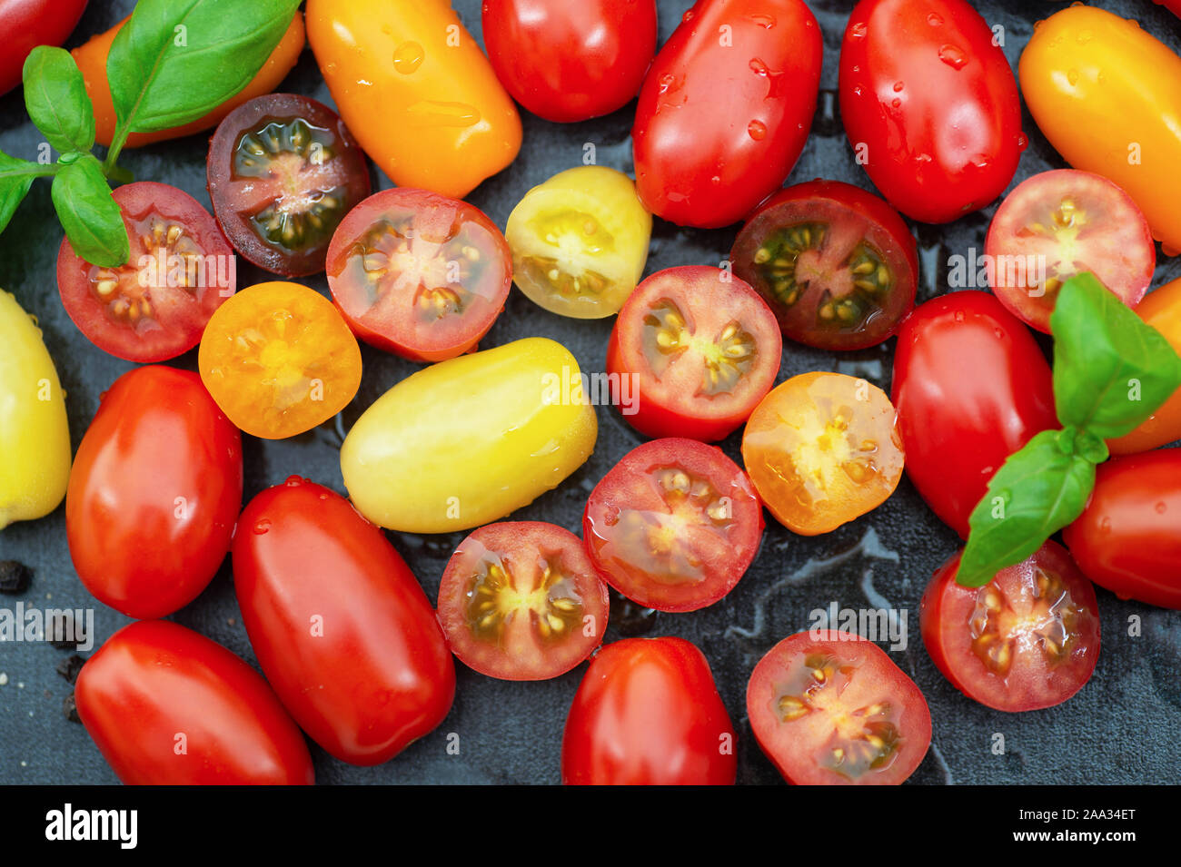 Mixed color tomatoes with olive oil Stock Photo