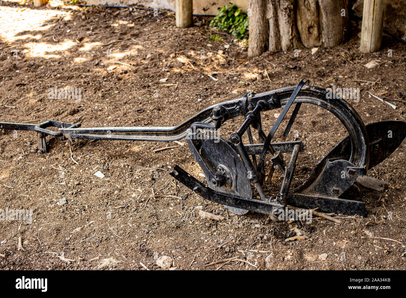 Old iron black farm plow on the dry grass in Israel's northern city of Rosh Pina Stock Photo
