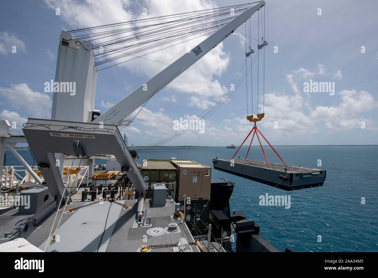 191113-N-CO914-1168  DIEGO GARCIA, British Indian Ocean Territory (November 13, 2019) An Improved Navy Lighterage System (INLS) Intermediate Module is offloaded by a crane aboard Military Sealift Command Bob Hope-class roll-on roll-off vehicle cargo ship USNS Seay (T-AKR 302) during an INLS training mission. Navy Cargo Handling Battalion (NCHB) 1, NCHB 8, NCHB 11, NCHB 13, Assault Craft Unit (ACU) 1 and Amphibious Construction Battalion (ACB) 1 are participating in the INLS training mission under the direction of Commander, Task Force (CTF) 75 in preparation for upcoming joint cargo handling e Stock Photo