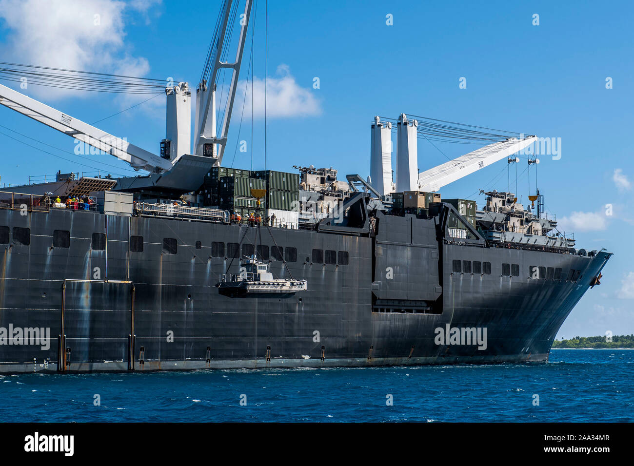 191111-N-CO914-1071  DIEGO GARCIA, British Indian Ocean Territory (November 11, 2019) Sailors lower a maritime prepositioning force utility boat from Military Sealift Command Bob Hope-class roll-on roll-off vehicle cargo ship USNS Seay (T-AKR 302) using a crane during an Improved Navy Lighterage System (INLS) training mission. Navy Cargo Handling Battalion (NCHB) 1, NCHB 8, NCHB 11, NCHB 13, Assault Craft Unit (ACU) 1 and Amphibious Construction Battalion (ACB) 1 are participating in the INLS training mission under the direction of Commander, Task Force (CTF) 75 in preparation for upcoming joi Stock Photo