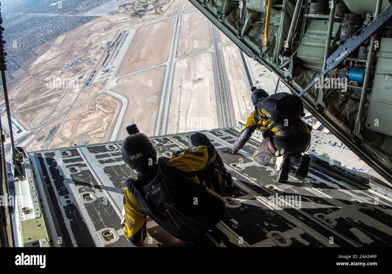Members of the Special Operations Command (SOCOM) Para-Commandos parachute demonstration team looks out of an HC-130J Combat King II aircraft over Nellis AFB, Nevada, Nov. 15, 2019.  The SOCOM Para-Commandos are comprised of active duty Special Operators, such as Army Special Forces, Army Rangers, Navy SEALs, Air Force Combat Controllers and Marine Raiders. (U.S. Air Force photo by Airman 1st Class Dwane R. Young) Stock Photo