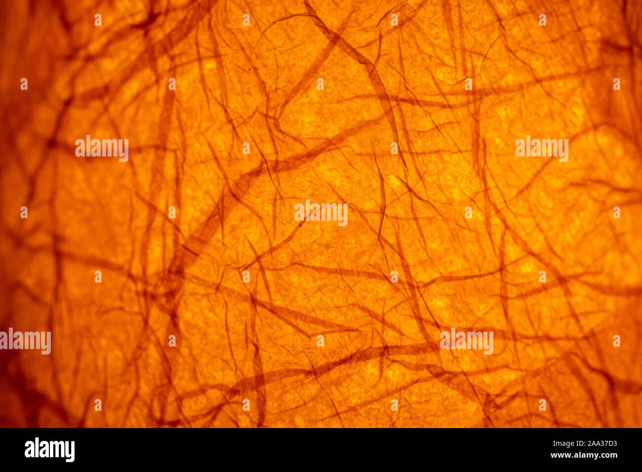 Abstract illuminated orange background from paper on an old lantern in a restaurant Stock Photo