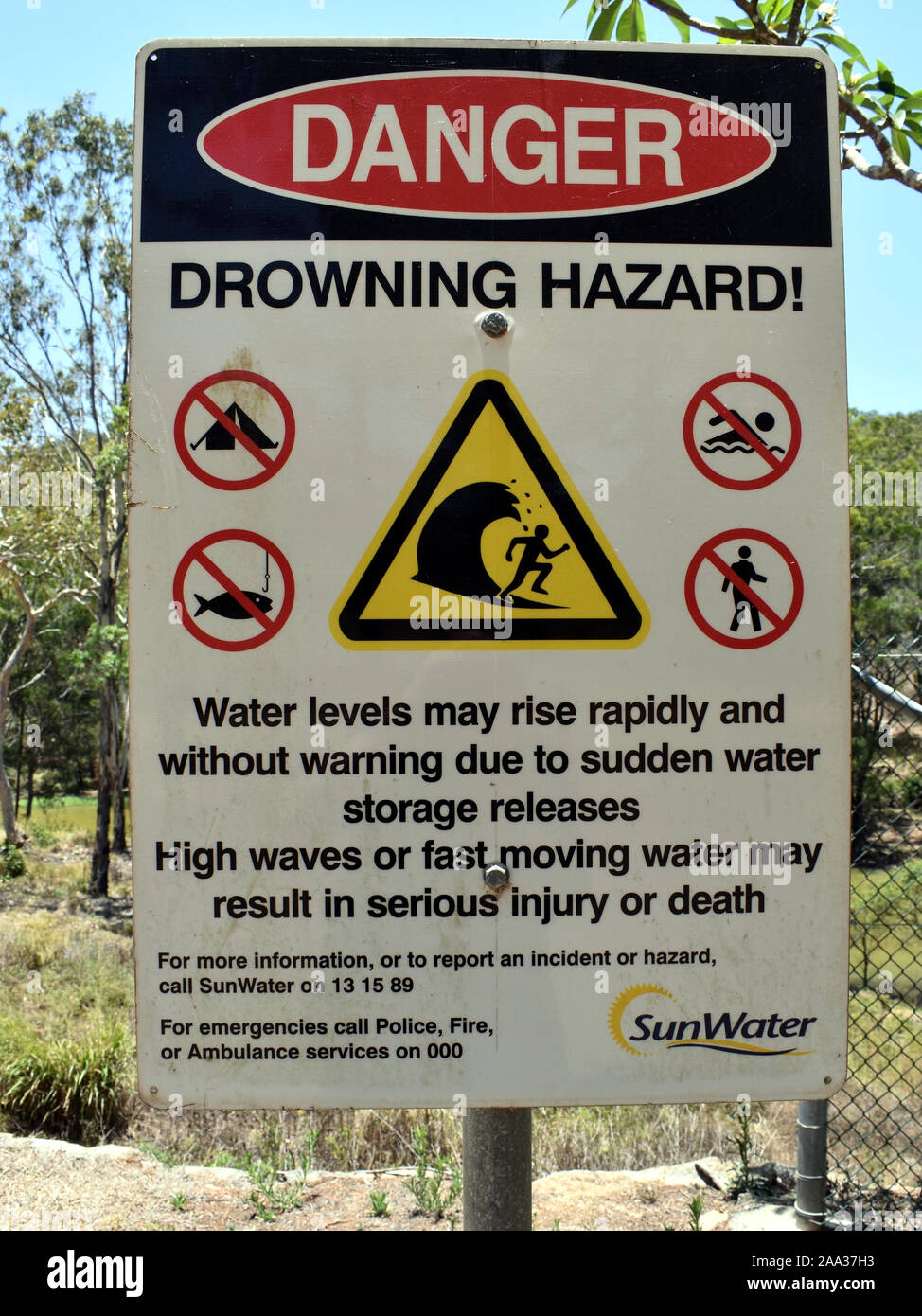 A danger sign beneath a dam warning of drowning hazard Stock Photo