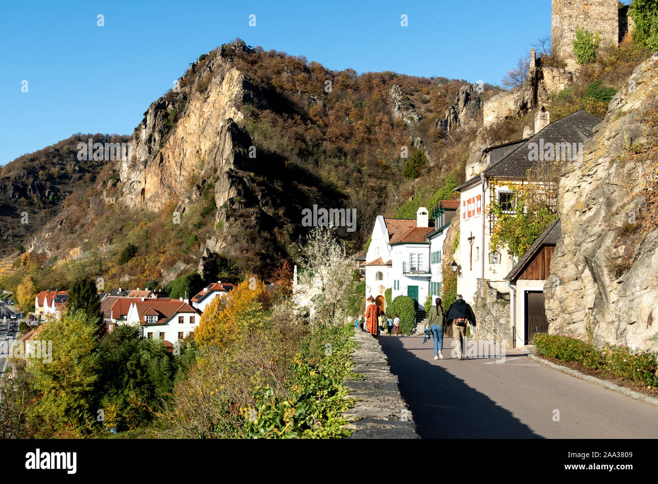 People walking along the mountain road to the modern part of Durnstein, Austria, with the mountains the background Stock Photo
