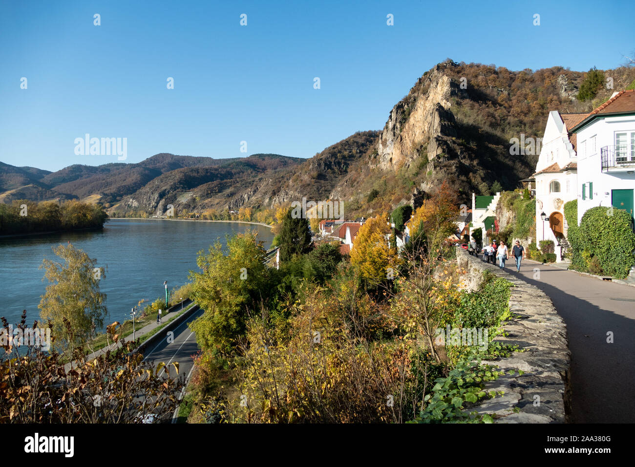 People walking along the mountain road to the modern part of Durnstein, alongside the river Danube Stock Photo