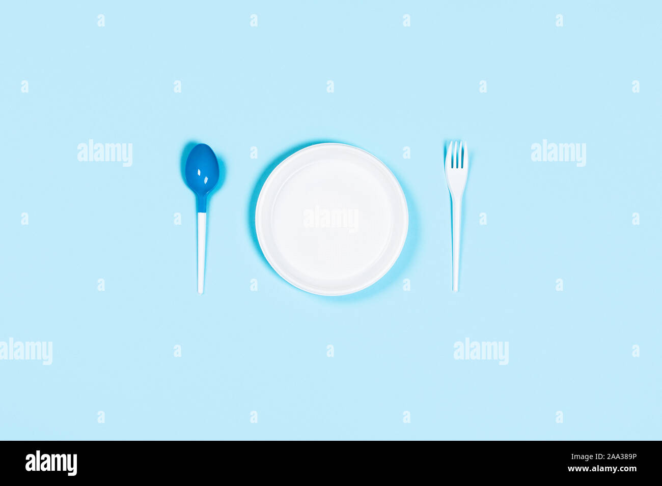 Plastic concept. Bad utensils on blue background. Flat lay, top view