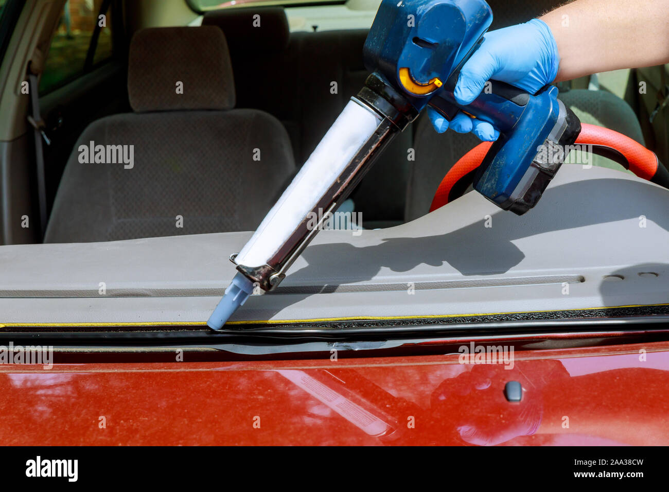 Close up car glaze worker silicone glue a windshield of a car at a service  station glass for replacement Stock Photo - Alamy
