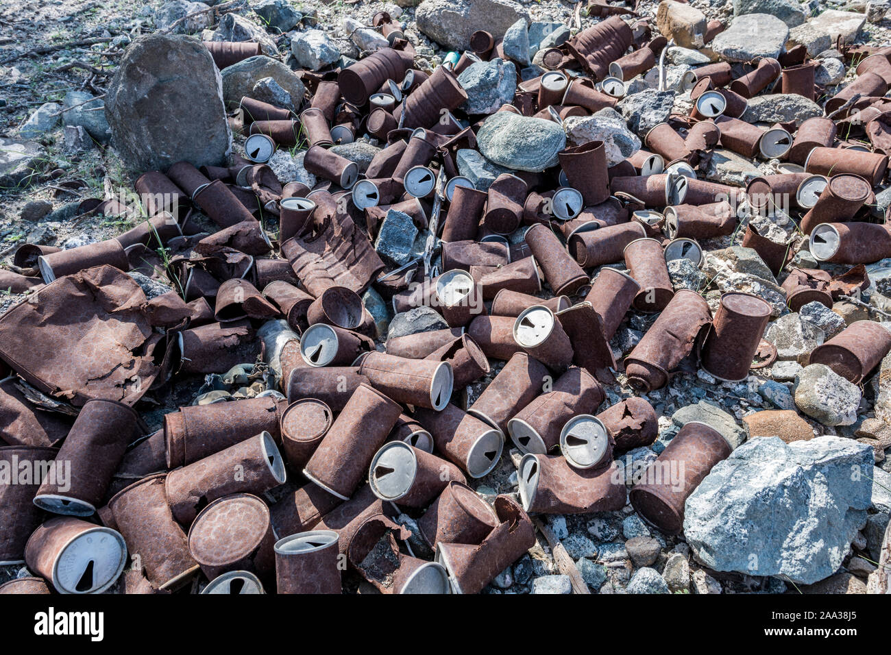 Rusted cans disposed on the ground, environmental issue Stock Photo