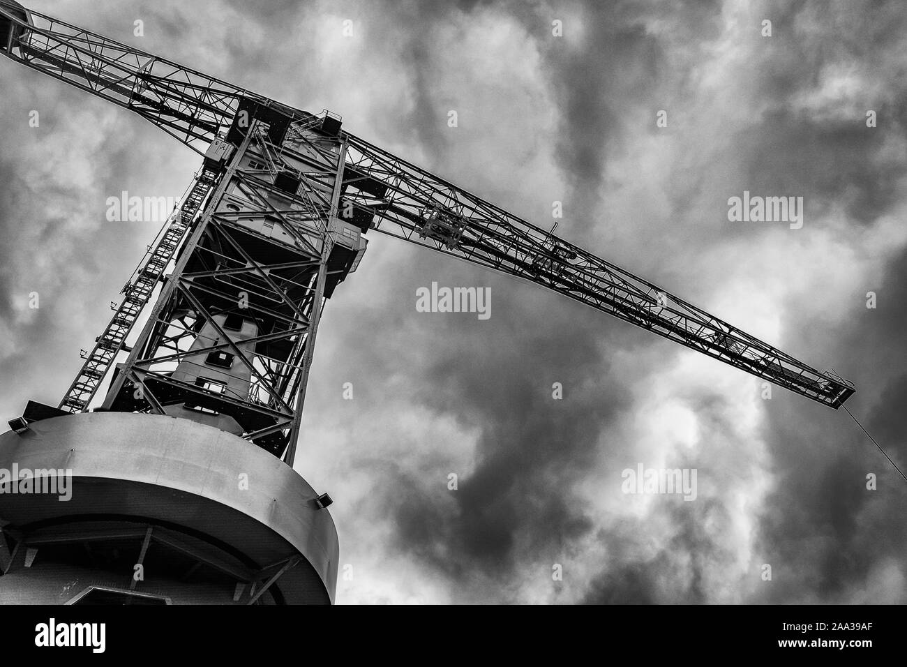 NDSM Crane, old crane, dark clouds, dramatic sky, Black and white picture, postcard, abstract background, wallpaper, old industry, Amsterdam Noord Stock Photo
