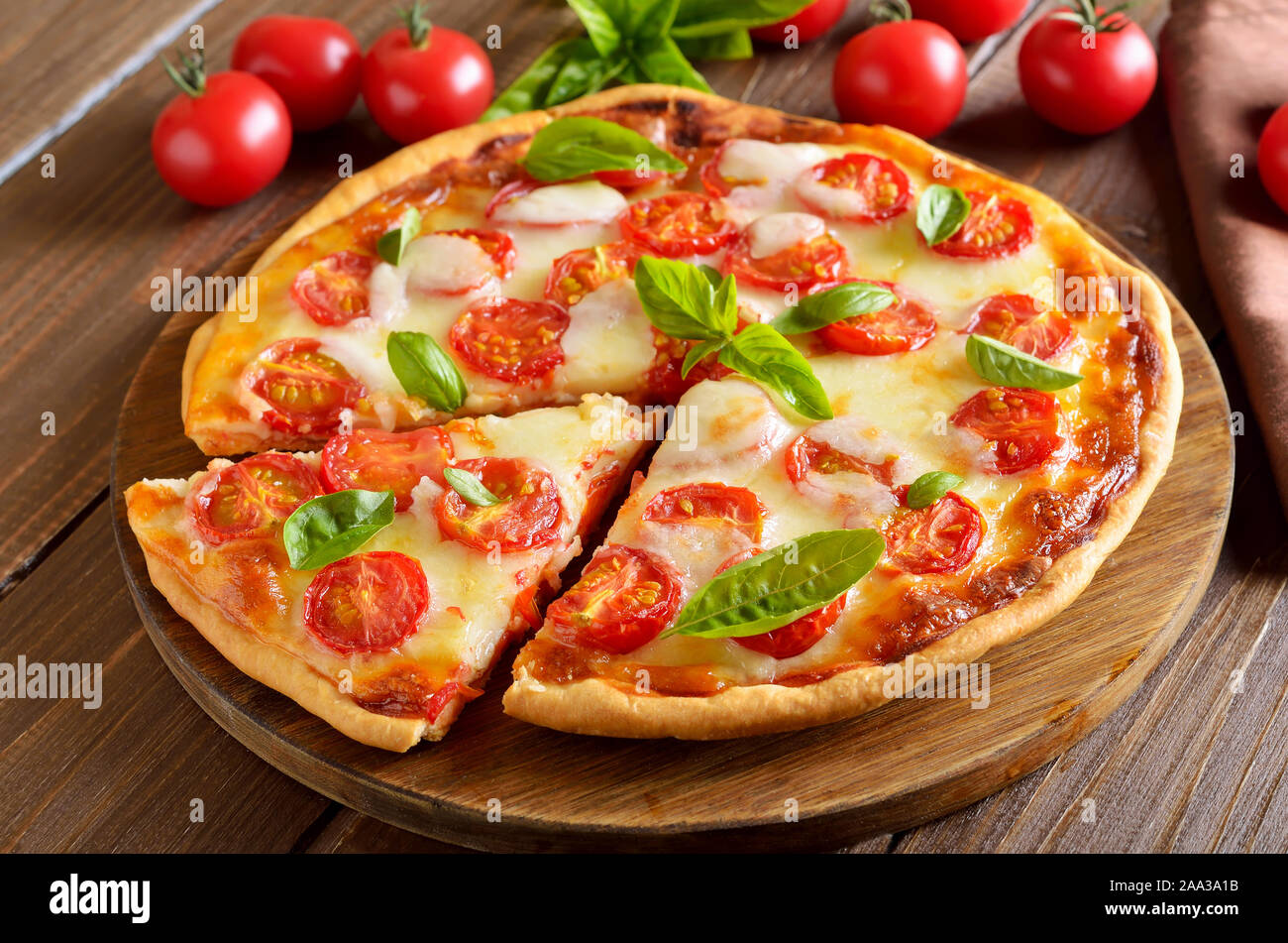 Sliced pizza Margarita on wooden table, close up view Stock Photo