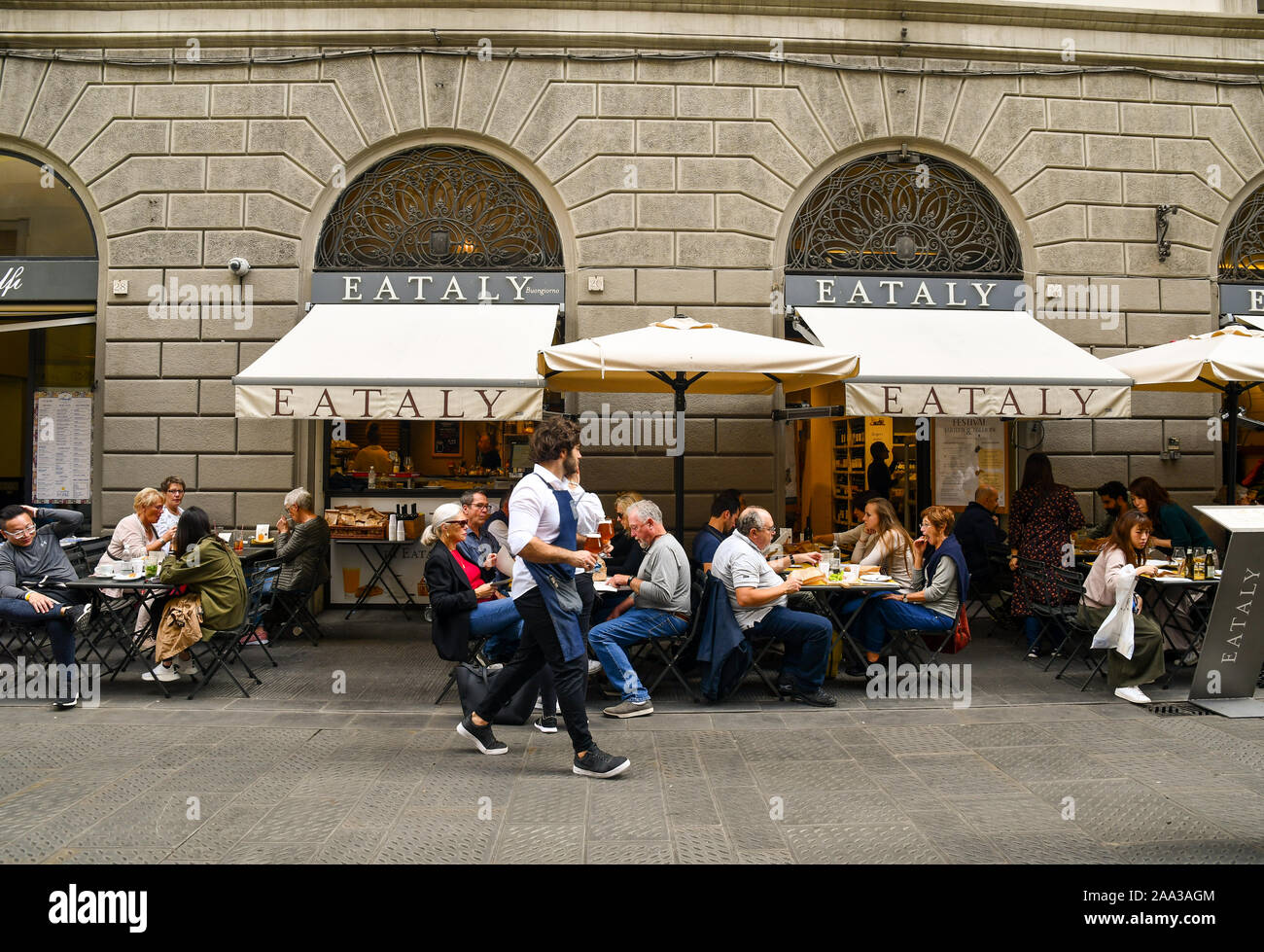 People and tourists enjoying lunch at Eataly outdoor restaurant in the historic centre of Florence, Tuscany, Italy Stock Photo