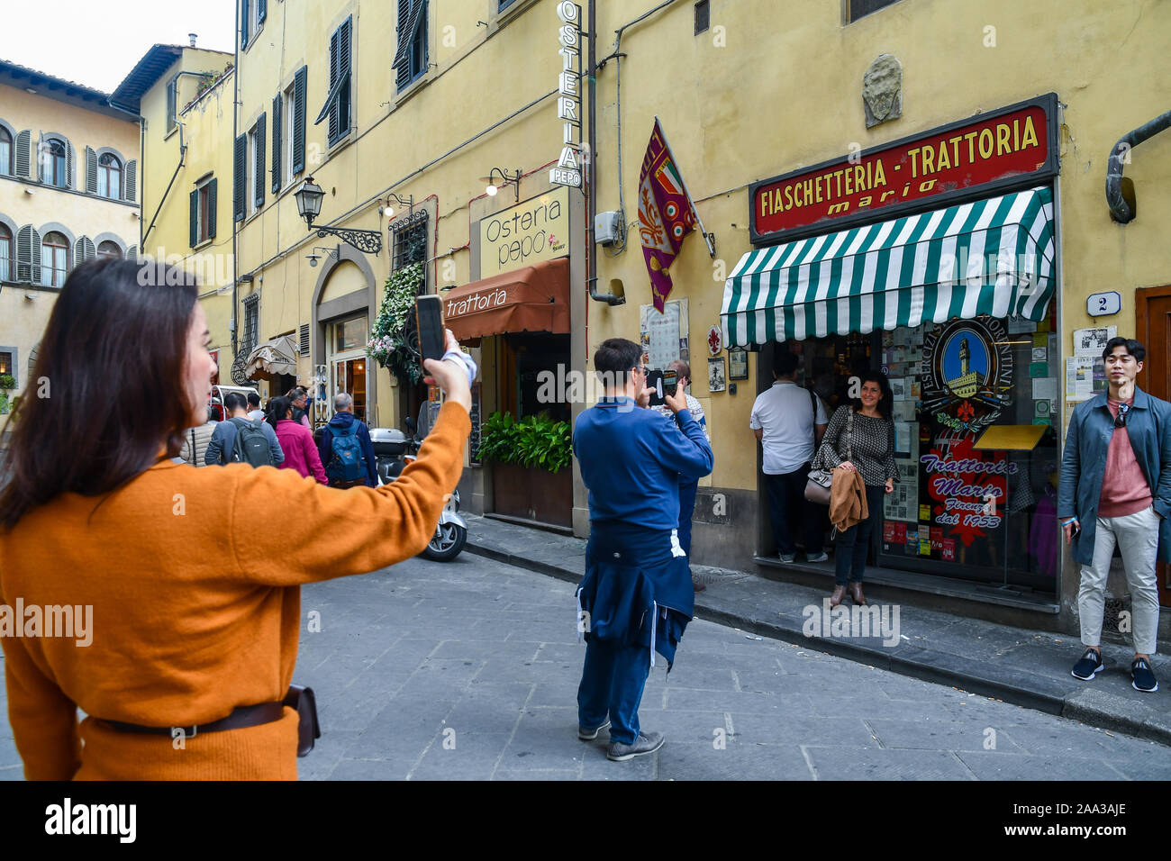 Tourists taking souvenir pictures in front of the Trattoria Mario, a famous restaurant serving typical Florentine cuisine, Florence, Tuscany, Italy Stock Photo
