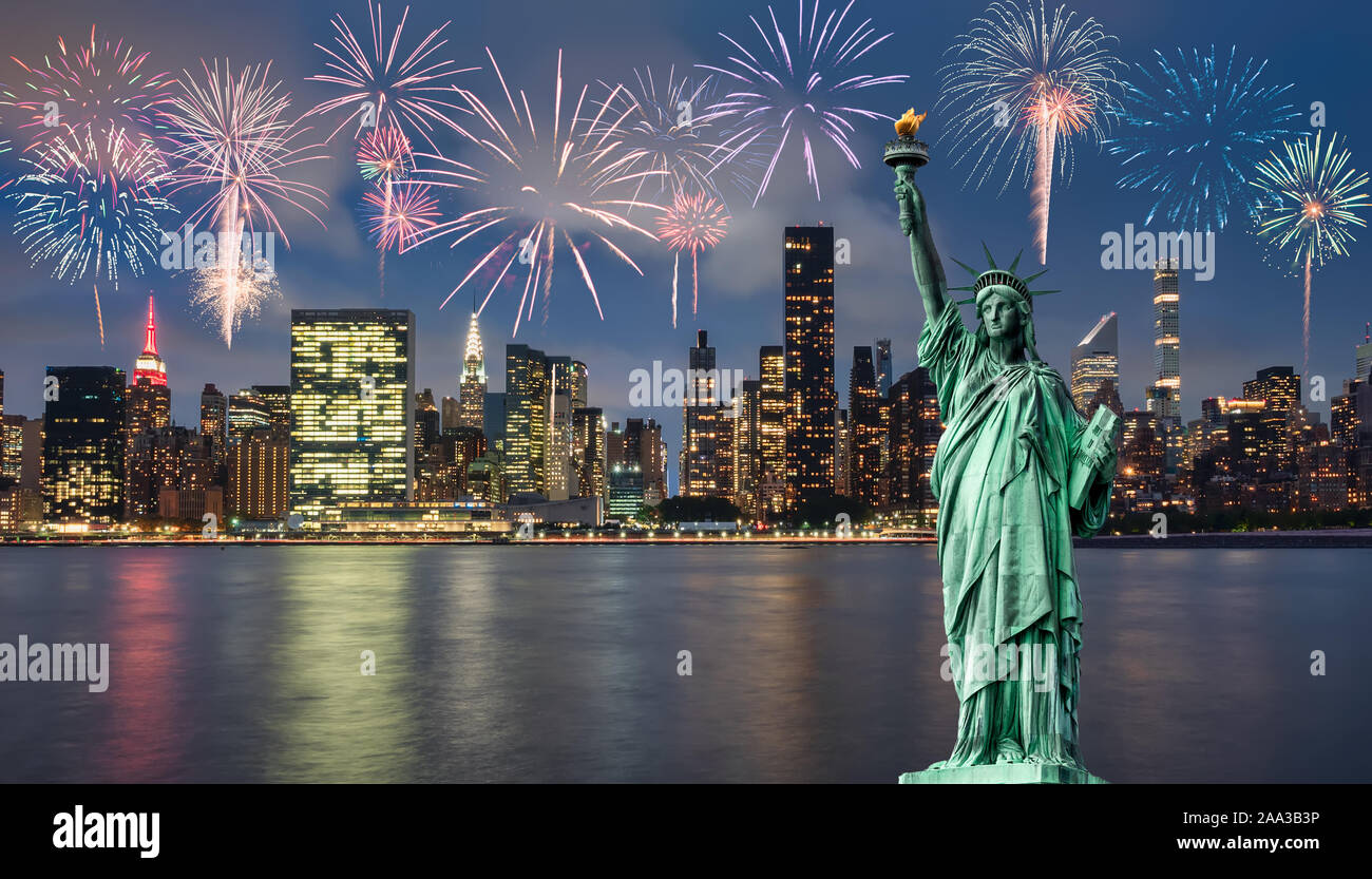 Statue of liberty in front of Manhattan skyline, at night, during blue hour Stock Photo