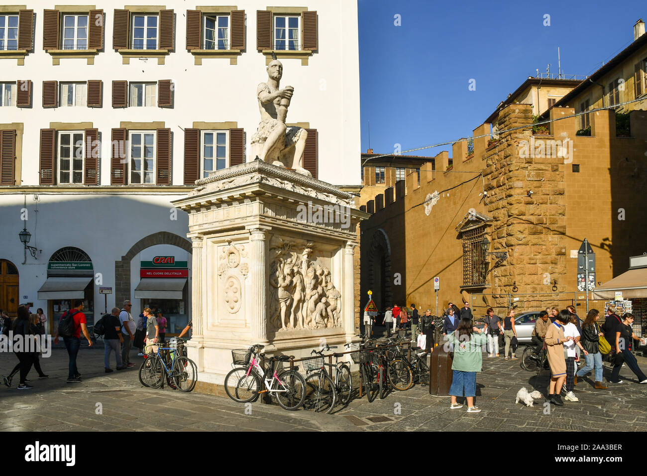 Monument to Giovanni delle Bande Nere in Piazza San Lorenzo, square in the historic centre of Florence, with people and tourists, Tuscany, Italy Stock Photo
