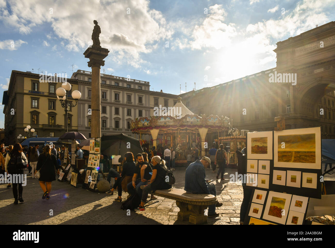 Backlight view of Republic Square in the historic centre of Florence with the Column of Abundance, the carousel and souvenir stalls, Tuscany, Italy Stock Photo