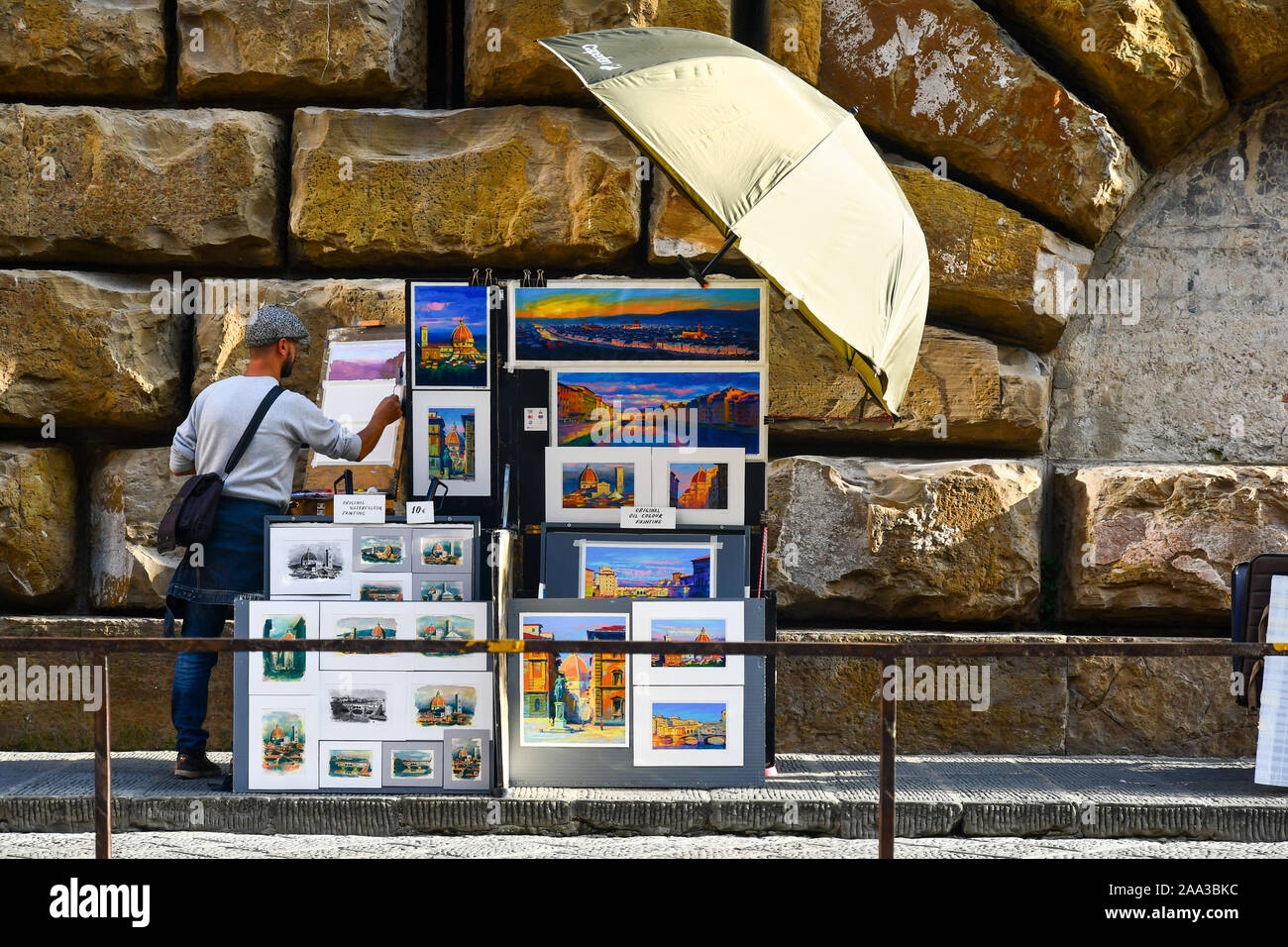 Street artist painting souvenir landscapes in Piazza de Pitti in the historic centre of Florence, Tuscany, Italy Stock Photo