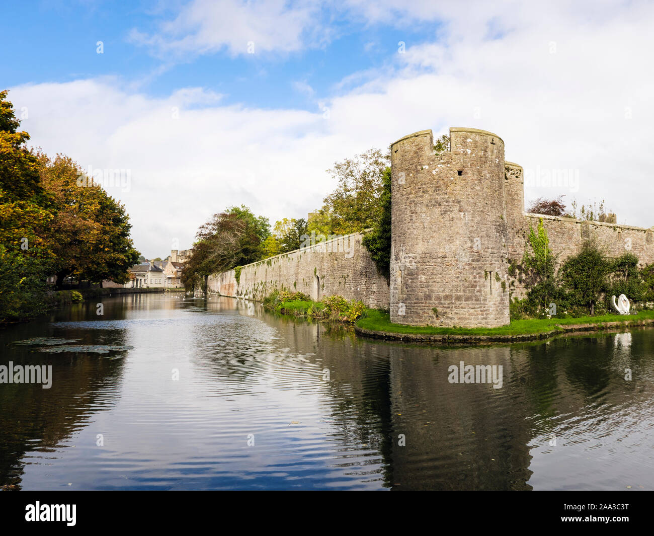 The 14th century walls and moat around the Bishop's Palace in autumn. Wells, Mendip, Somerset, England, UK, Britain Stock Photo