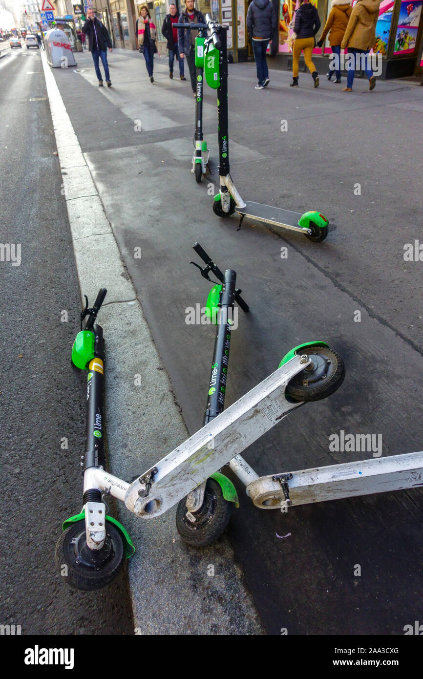 Sharing electric scooters on pavement, street view Stock Photo