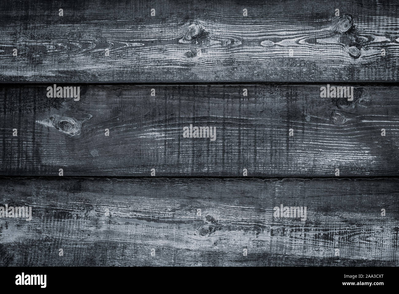 Shabby dark wood texture. Vintage wooden black fence, desk surface. Natural gray color. Weathered timber background. Dirty old wood planks. Stock Photo
