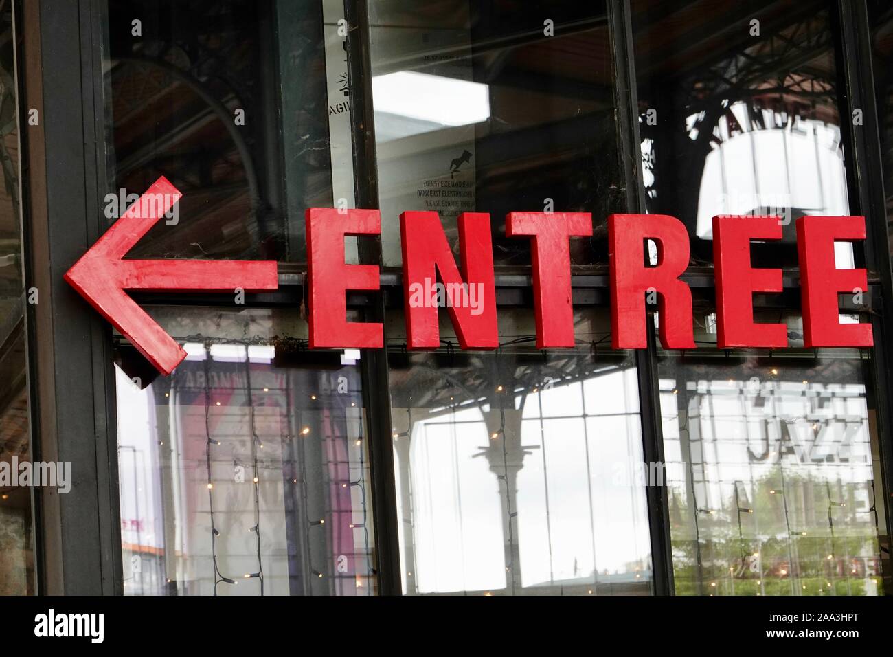 Red entree sign with horizontal arrow, Parc Villette, Paris, France. Stock Photo