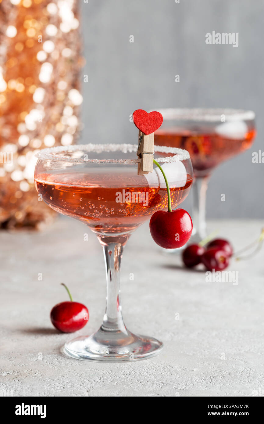 Holiday drink with sweet cherry with shine and gray background. Cover for magazine on holiday. Concept of festive drinks Stock Photo