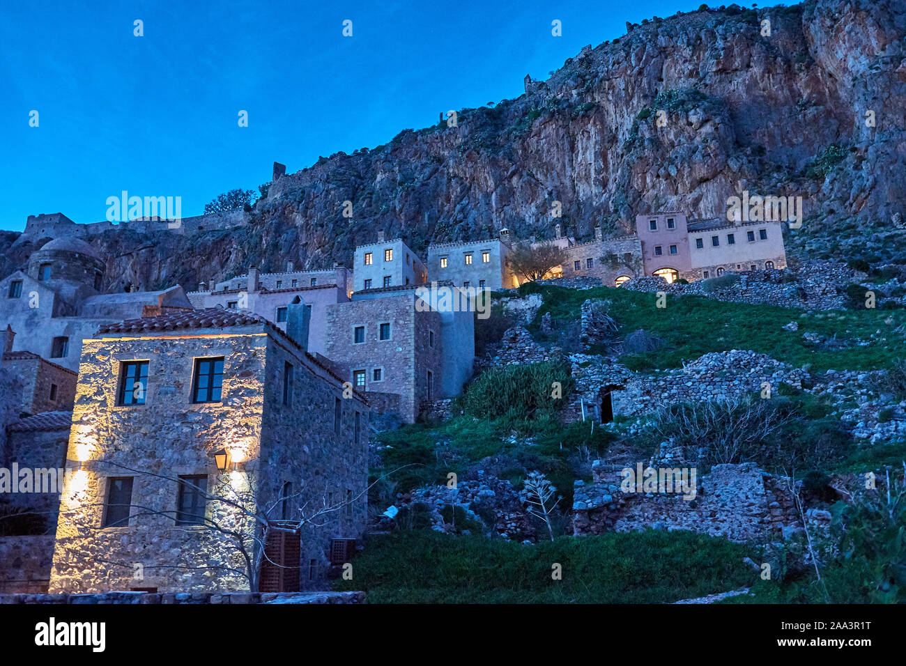 Stone alley into the picturesque castle town of Monemvasia during winter. Architectural stone buildings and beautiful narrow paved streets. Stock Photo